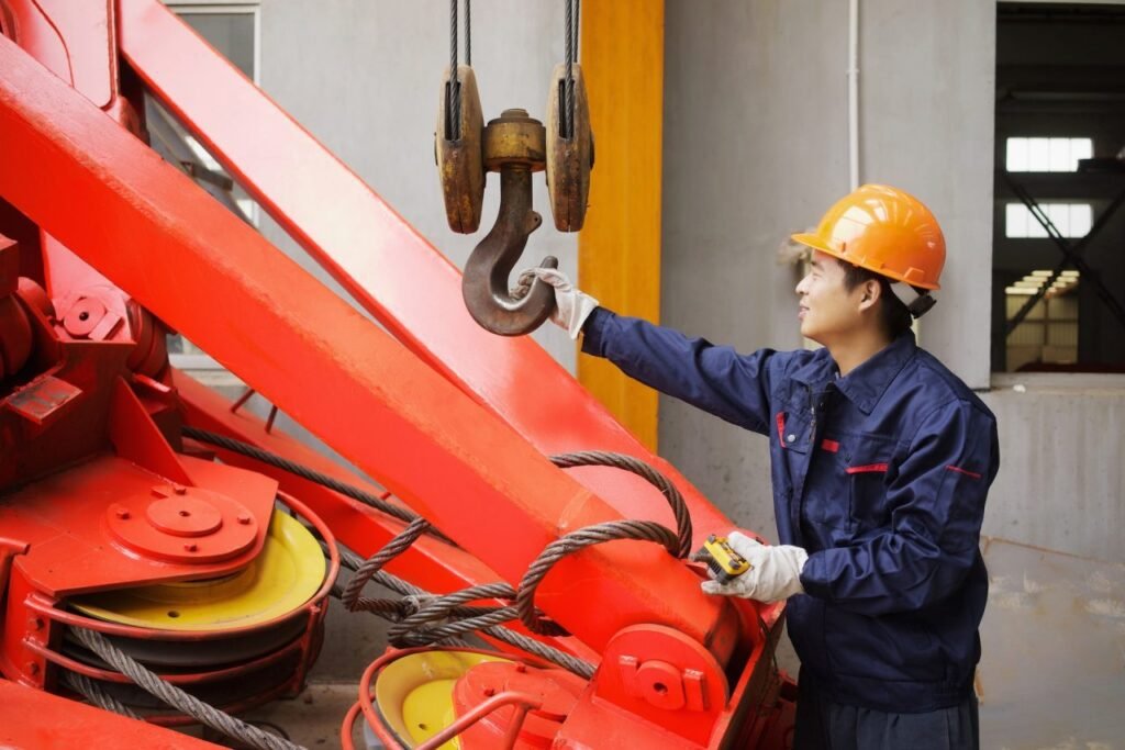 worker using equipment in crane manufacturing facility china